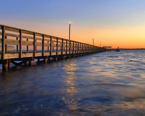 Sunset, boardwalk, and water